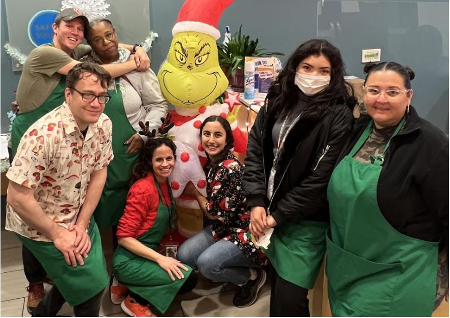 Safe & Sound Staff pose with the Grinch at the 2023 Toy Store.