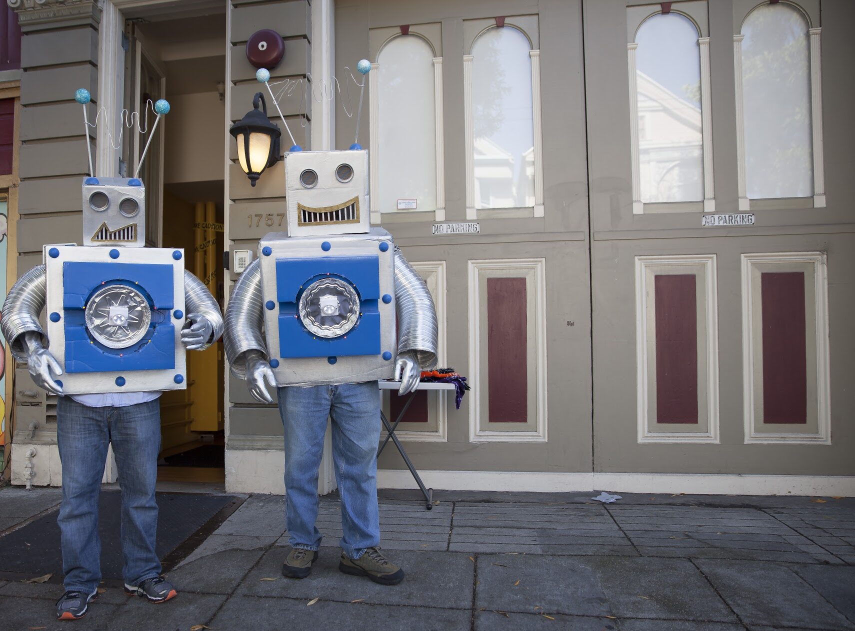 2 people dressed up as robots stand in front of the Safe & Sound office at Waller Street