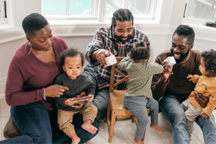 3 parents and 3 children play together with toy bricks