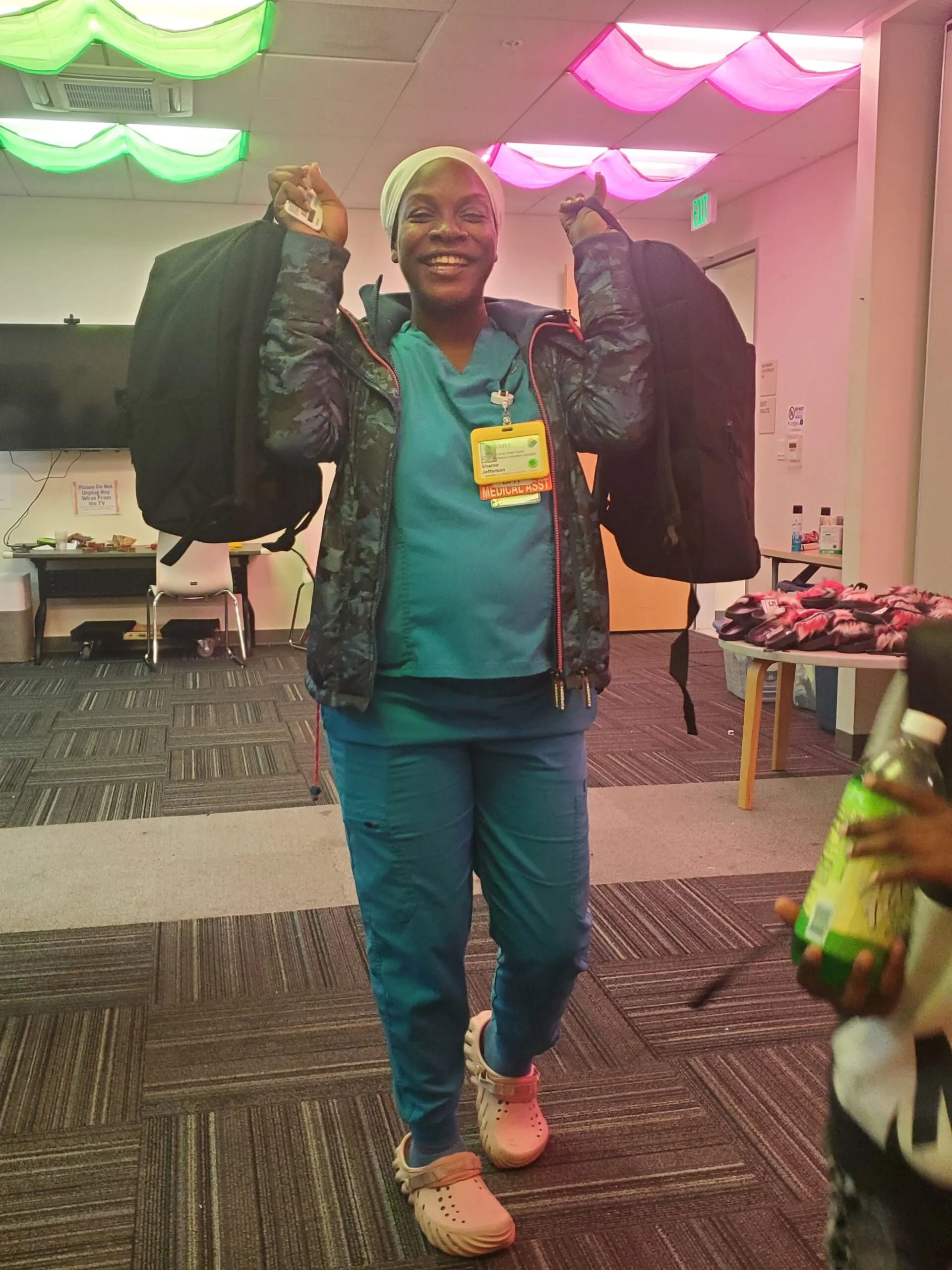 A mother smiling with 2 new backpacks