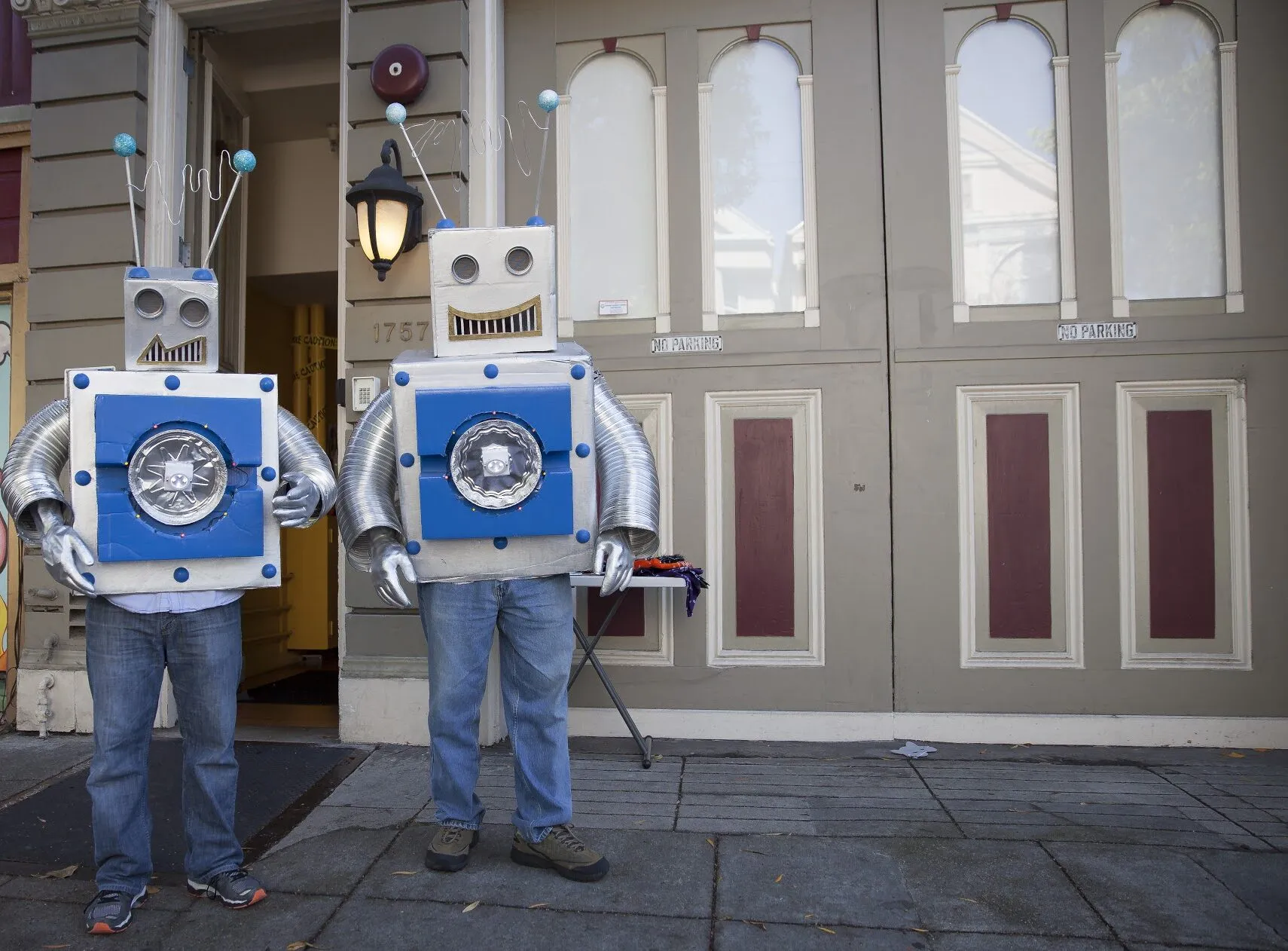 2 people dressed up as robots stand in front of the Safe & Sound office at Waller Street